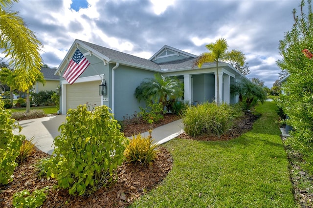 3631 Shimmering Oaks Dr, Parrish, FL 34219 - view of side of home featuring an attached garage, stucco siding, concrete driveway, a yard, and a shingled roof