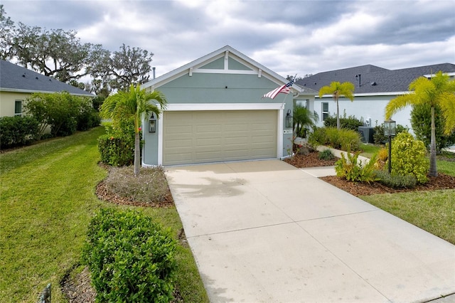 3631 Shimmering Oaks Dr, Parrish, FL 34219 - view of front of property featuring a front lawn, a garage, concrete driveway, and stucco siding