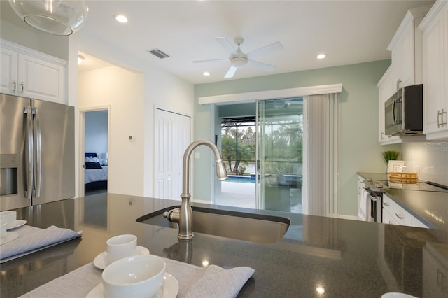 3631 Shimmering Oaks Dr, Parrish, FL 34219 - kitchen featuring appliances with stainless steel finishes, a sink, white cabinets, a ceiling fan, and recessed lighting