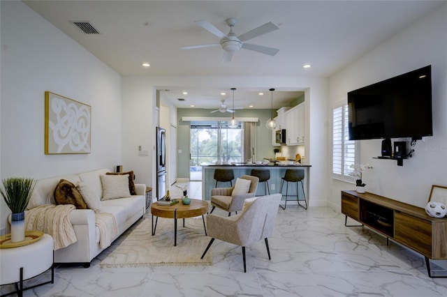 3631 Shimmering Oaks Dr, Parrish, FL 34219 - living area with light marble finish floors, healthy amount of natural light, ceiling fan, recessed lighting, and baseboards