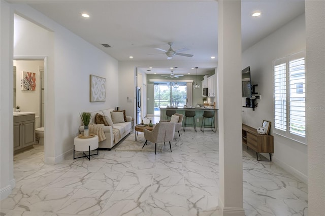 3631 Shimmering Oaks Dr, Parrish, FL 34219 - living area featuring a ceiling fan, recessed lighting, light marble finish floors, and baseboards