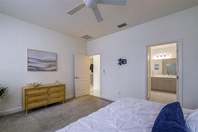 3631 Shimmering Oaks Dr, Parrish, FL 34219 - bedroom featuring connected bathroom, light carpet, baseboards, and a sink