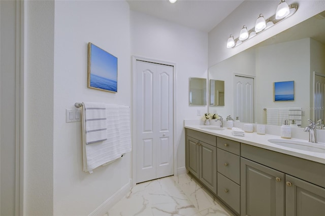 3631 Shimmering Oaks Dr, Parrish, FL 34219 - bathroom featuring marble look tiles, double vanity, and baseboards