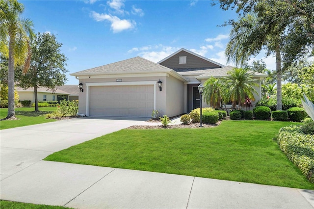 5020 Torrey Pines Run, Bradenton, FL 34211 - view of front of house featuring a garage, a front lawn, driveway, and stucco siding