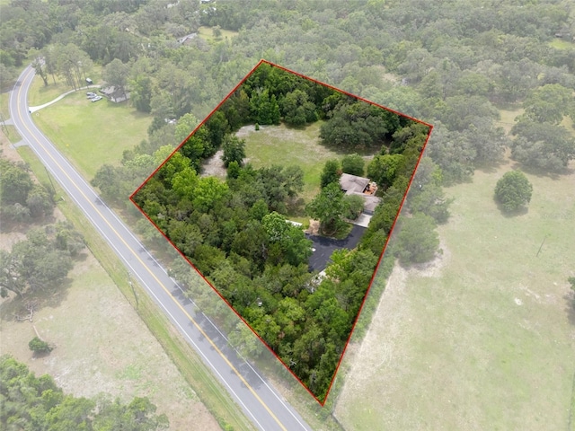 22063 Lake Lindsey Rd, Brooksville, FL 34601 - aerial view of property and surrounding area with property boundaries highlighted and a heavily wooded area