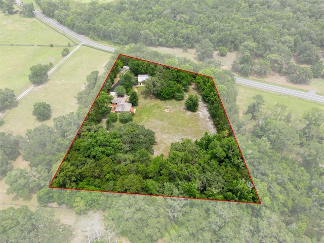 22063 Lake Lindsey Rd, Brooksville, FL 34601 - aerial view of sparsely populated area featuring property parcel outlined and a heavily wooded area