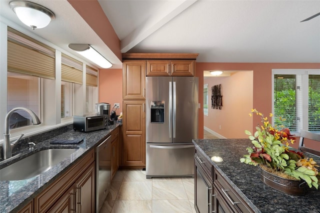 22063 Lake Lindsey Rd, Brooksville, FL 34601 - kitchen with appliances with stainless steel finishes, a sink, dark stone counters, and brown cabinets