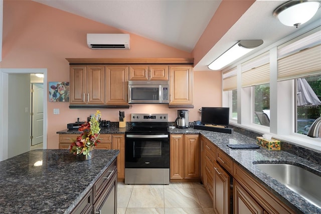 22063 Lake Lindsey Rd, Brooksville, FL 34601 - kitchen featuring stainless steel appliances, an AC wall unit, vaulted ceiling, a sink, and dark stone counters