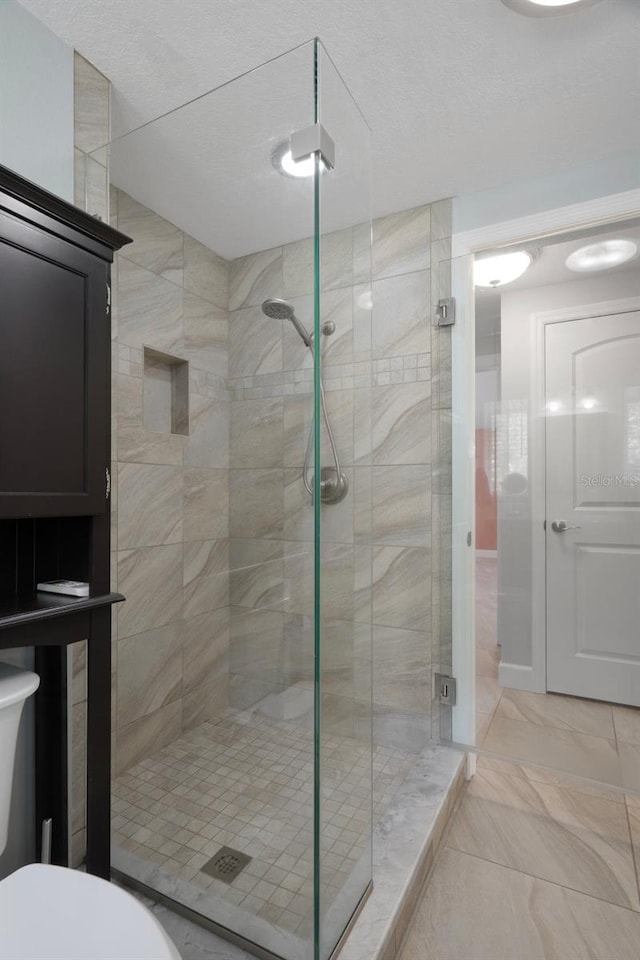 22063 Lake Lindsey Rd, Brooksville, FL 34601 - full bathroom featuring a shower stall, toilet, and marble finish flooring