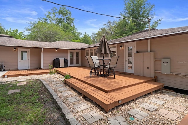 22063 Lake Lindsey Rd, Brooksville, FL 34601 - wooden terrace with french doors, grilling area, and outdoor dining area