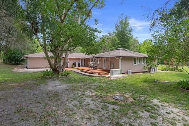 22063 Lake Lindsey Rd, Brooksville, FL 34601 - rear view of house with a deck and a lawn