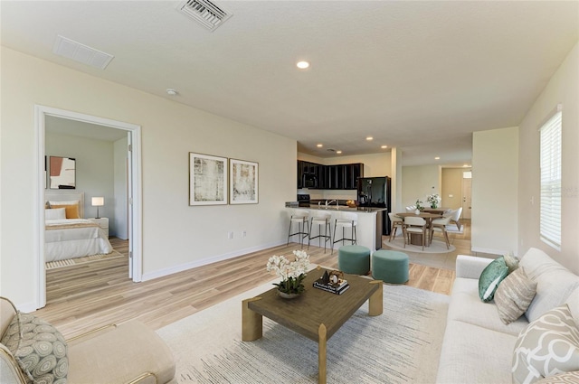 4206 Park Willow Ave, Palmetto, FL 34221 - living room with light wood-type flooring, recessed lighting, and baseboards