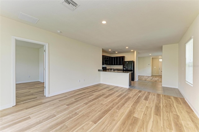 4206 Park Willow Ave, Palmetto, FL 34221 - unfurnished living room with light wood-style floors, recessed lighting, and baseboards