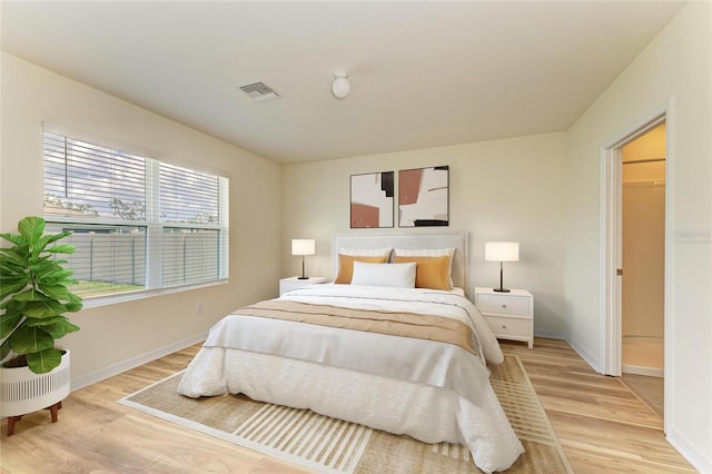 4206 Park Willow Ave, Palmetto, FL 34221 - bedroom featuring light wood-style floors, baseboards, and a walk in closet