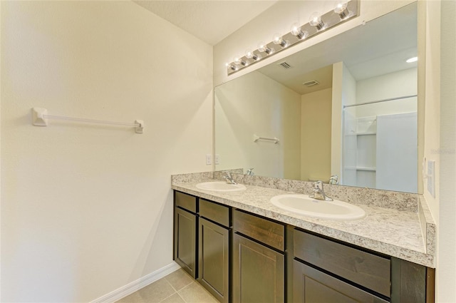 4206 Park Willow Ave, Palmetto, FL 34221 - bathroom featuring double vanity, tile patterned flooring, and baseboards
