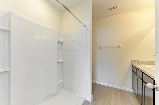 4206 Park Willow Ave, Palmetto, FL 34221 - bathroom featuring a shower, vanity, tile patterned flooring, and baseboards