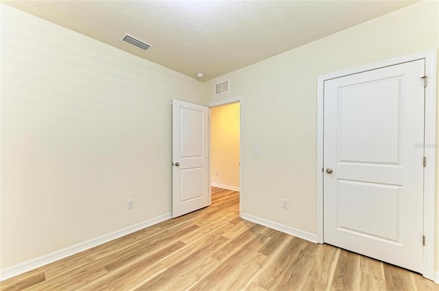 4206 Park Willow Ave, Palmetto, FL 34221 - unfurnished bedroom featuring light wood-style floors, baseboards, and a textured ceiling