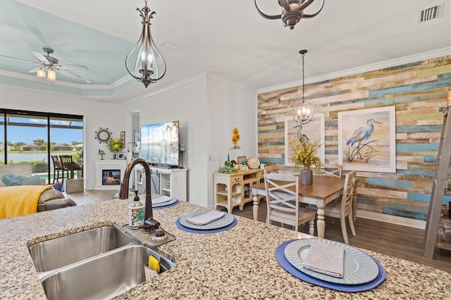 13849 Old Creek Ct, Parrish, FL 34219 - kitchen featuring a sink, a ceiling fan, wood finished floors, open floor plan, and crown molding