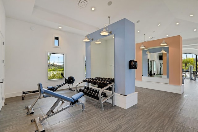2794 Butterfly Jasmine Trl, Sarasota, FL 34240 - workout room with recessed lighting, a high ceiling, baseboards, and wood finished floors
