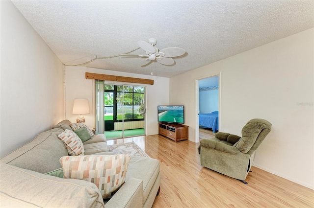 6030 7th Ave W Unit 6030, Bradenton, FL 34209 - living area featuring radiator, light wood finished floors, a textured ceiling, and a ceiling fan