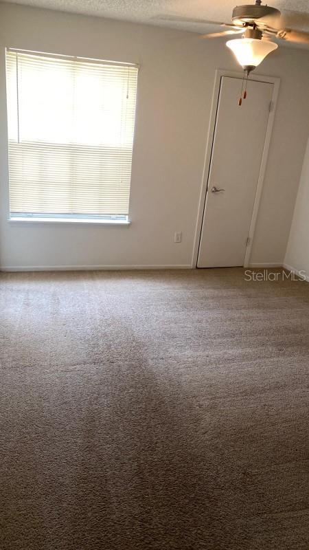 1948 Lake Atriums Cir Unit 132, Orlando, FL 32839 - empty room featuring ceiling fan, baseboards, and light carpet