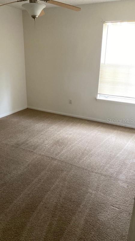 1948 Lake Atriums Cir Unit 132, Orlando, FL 32839 - carpeted spare room with plenty of natural light, a ceiling fan, and baseboards