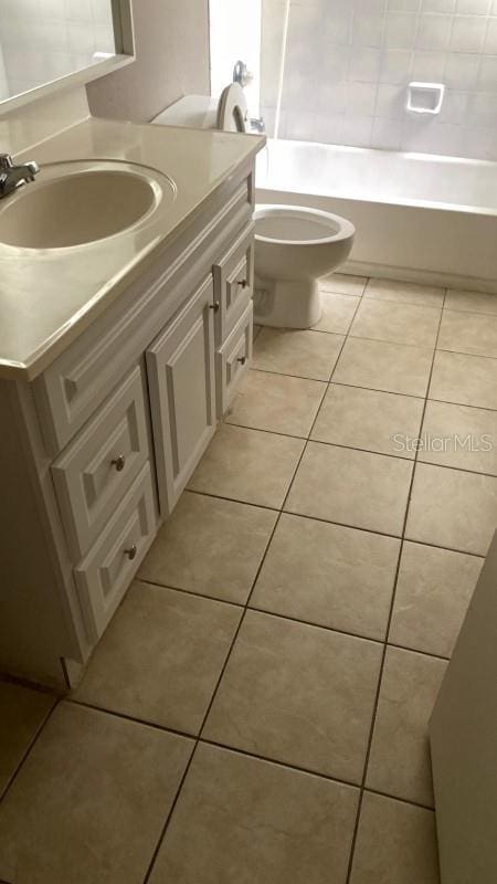 1948 Lake Atriums Cir Unit 132, Orlando, FL 32839 - bathroom featuring vanity, tile patterned flooring, toilet, and shower / washtub combination