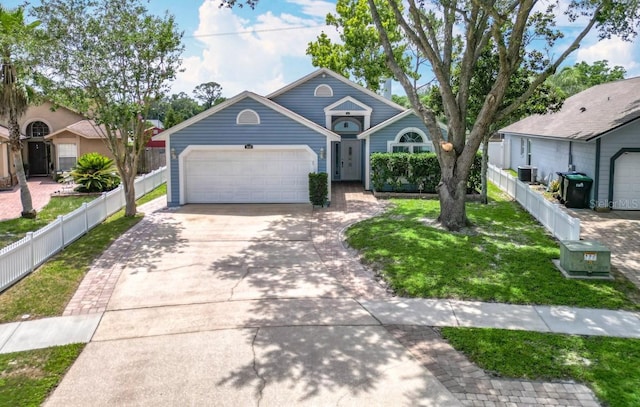 2641 Delcrest Dr, Orlando, FL 32817 - view of front of property with concrete driveway, a garage, and cooling unit