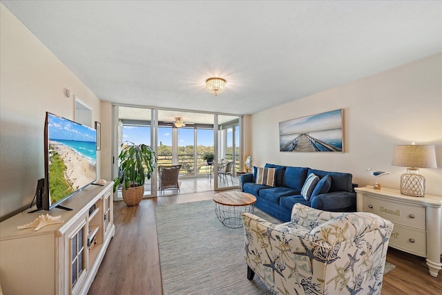 4570 Pinebrook Cir Unit 508, Bradenton, FL 34209 - living room featuring floor to ceiling windows, wood finished floors, and a ceiling fan