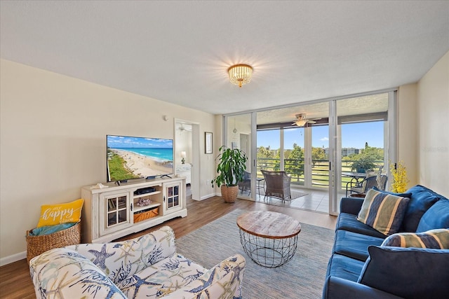 4570 Pinebrook Cir Unit 508, Bradenton, FL 34209 - living area featuring a wall of windows, baseboards, wood finished floors, and a ceiling fan