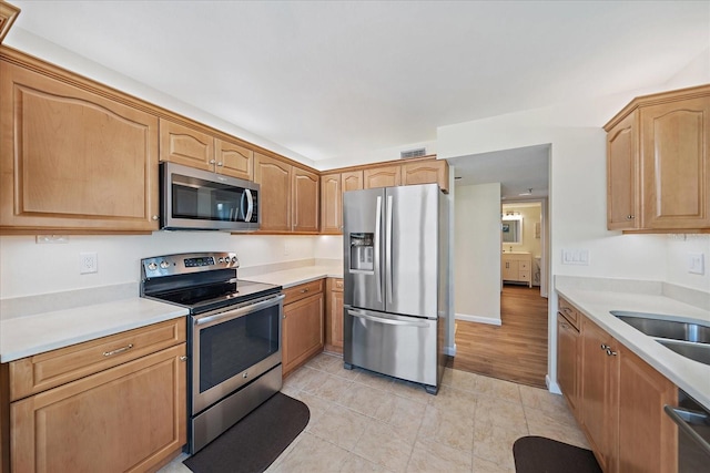 4570 Pinebrook Cir Unit 508, Bradenton, FL 34209 - kitchen with appliances with stainless steel finishes, light countertops, light tile patterned flooring, and a sink