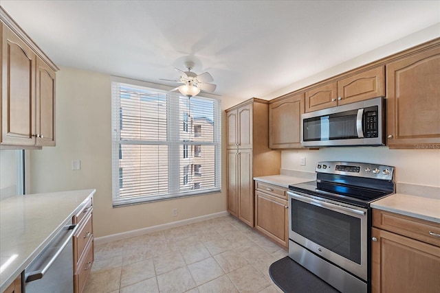 4570 Pinebrook Cir Unit 508, Bradenton, FL 34209 - kitchen featuring appliances with stainless steel finishes, light countertops, baseboards, ceiling fan, and light tile patterned floors