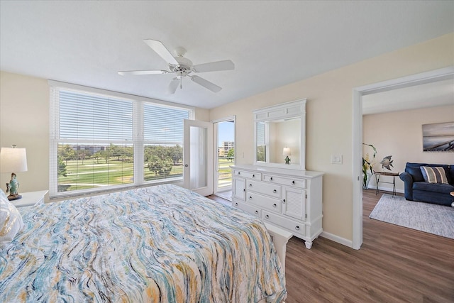 4570 Pinebrook Cir Unit 508, Bradenton, FL 34209 - bedroom with multiple windows, dark wood finished floors, baseboards, and access to exterior