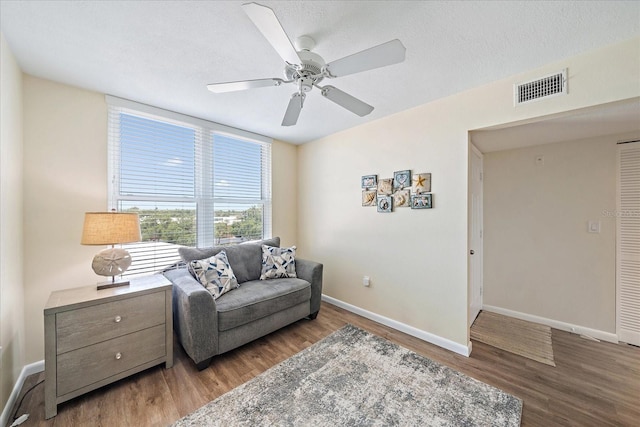 4570 Pinebrook Cir Unit 508, Bradenton, FL 34209 - living area featuring wood finished floors, baseboards, ceiling fan, and a textured ceiling