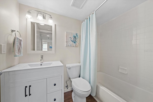 4570 Pinebrook Cir Unit 508, Bradenton, FL 34209 - bathroom with toilet, vanity, shower / bath combination with curtain, wood finished floors, and baseboards