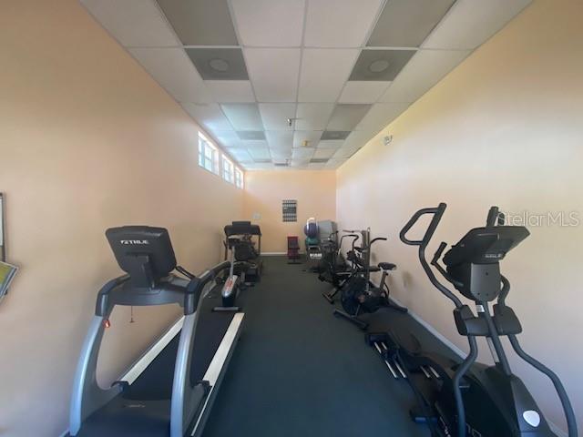 4570 Pinebrook Cir Unit 508, Bradenton, FL 34209 - workout area with a drop ceiling and baseboards