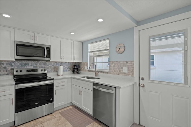 6150 Midnight Pass Rd Unit V4, Sarasota, FL 34242 - kitchen with stainless steel appliances, a sink, tasteful backsplash, white cabinets, and recessed lighting