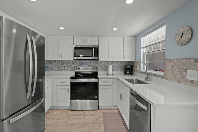 6150 Midnight Pass Rd Unit V4, Sarasota, FL 34242 - kitchen with appliances with stainless steel finishes, a sink, tasteful backsplash, white cabinetry, and recessed lighting