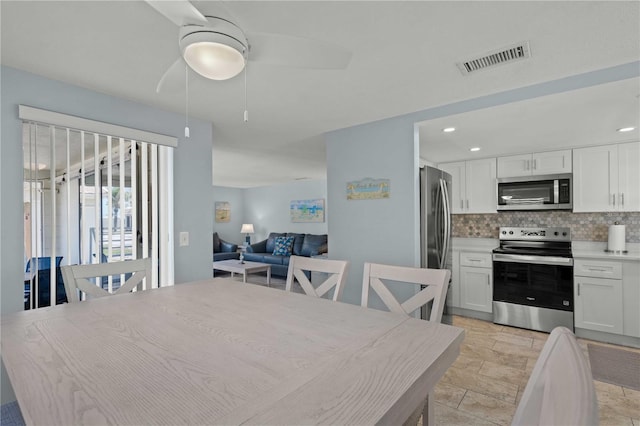 6150 Midnight Pass Rd Unit V4, Sarasota, FL 34242 - dining area featuring a ceiling fan, light stone finish floors, and recessed lighting