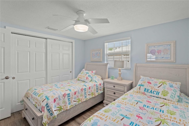 6150 Midnight Pass Rd Unit V4, Sarasota, FL 34242 - bedroom featuring a closet, dark wood finished floors, a textured ceiling, and a ceiling fan