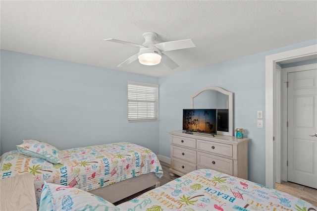 6150 Midnight Pass Rd Unit V4, Sarasota, FL 34242 - bedroom with a textured ceiling and ceiling fan