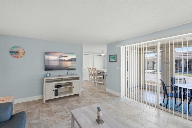 6150 Midnight Pass Rd Unit V4, Sarasota, FL 34242 - living room featuring a textured ceiling and baseboards