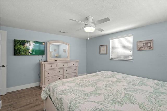 6150 Midnight Pass Rd Unit V4, Sarasota, FL 34242 - bedroom featuring wood finished floors, a textured ceiling, baseboards, and a ceiling fan