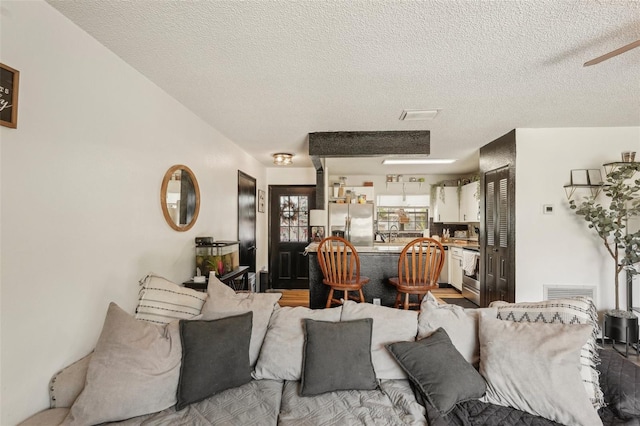 3881 Holin Ln, North Port, FL 34287 - living area with a textured ceiling and ceiling fan