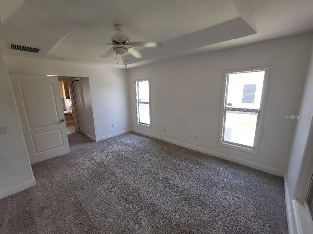 1422 Jakway Rd, North Port, FL 34288 - unfurnished bedroom featuring a raised ceiling, carpet, and baseboards