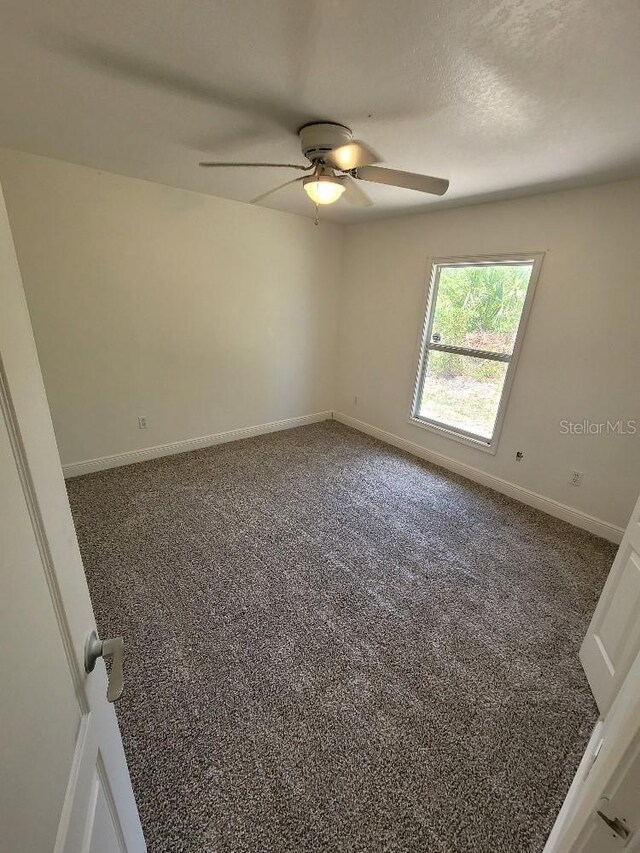 1422 Jakway Rd, North Port, FL 34288 - carpeted spare room with ceiling fan and baseboards