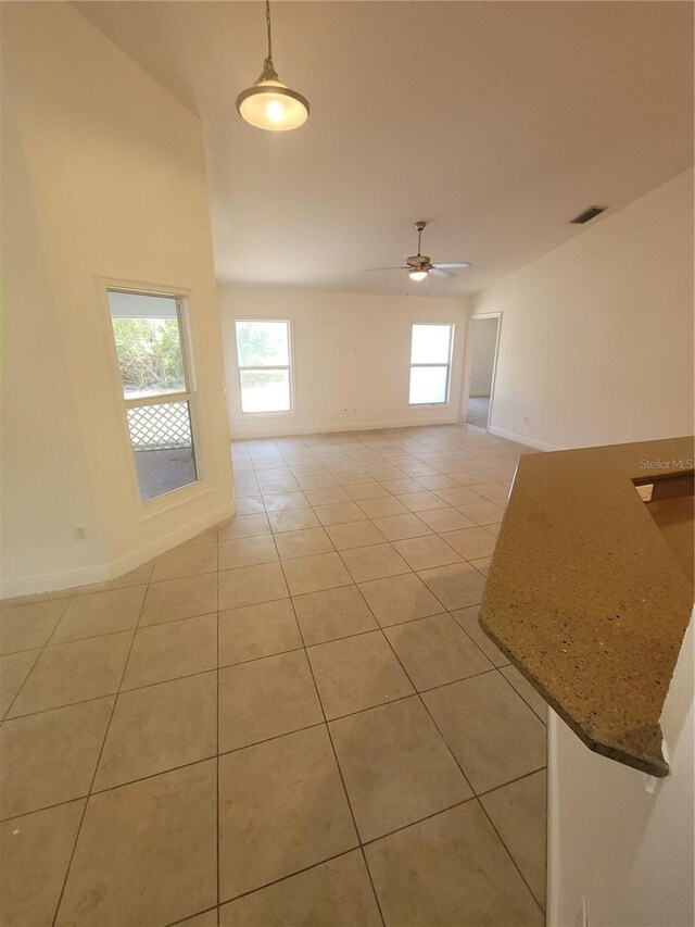 1422 Jakway Rd, North Port, FL 34288 - spare room with light tile patterned floors, baseboards, plenty of natural light, and a ceiling fan