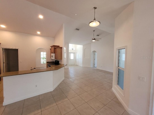 1422 Jakway Rd, North Port, FL 34288 - kitchen featuring arched walkways, range with electric stovetop, light tile patterned floors, a ceiling fan, and pendant lighting