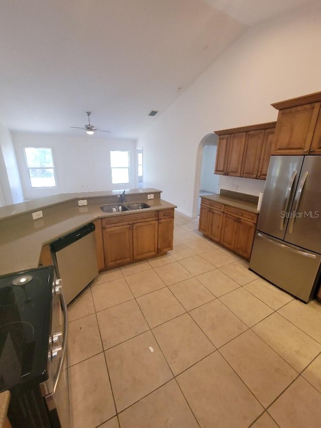 1422 Jakway Rd, North Port, FL 34288 - kitchen with freestanding refrigerator, dishwashing machine, range, a sink, and arched walkways