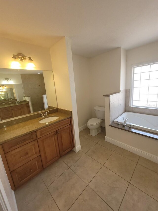 1422 Jakway Rd, North Port, FL 34288 - bathroom featuring tile patterned flooring, toilet, vanity, a bath, and baseboards